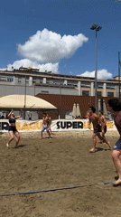 Young adults play volleyball, football in sunny Milan parks