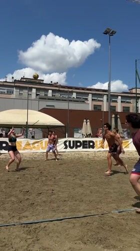 Young adults play volleyball, football in sunny Milan parks