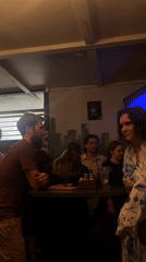 Bar patrons gather, review beer menu in Rusanovo