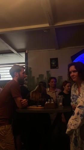 Bar patrons gather, review beer menu in Rusanovo