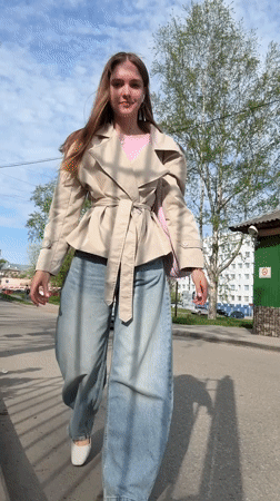 Woman in trench coat walks Perm streets amid blooming dandelions