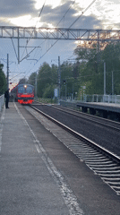 Evening commuter train activity documented at Komarovo station, Russia