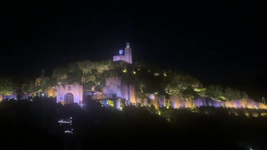 Veliko Tarnovo castle illuminated with changing colored lights at night