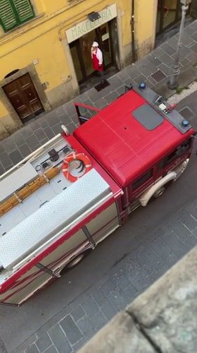 Firefighters respond to an incident on a Pescia cobblestone street