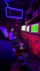 Late-night gaming session at graffiti-covered Buenos Aires arcade