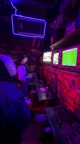 Late-night gaming session at graffiti-covered Buenos Aires arcade