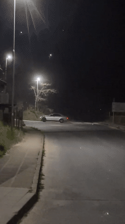 Car drifts at intersection in Zlatograd, Bulgaria creating dust cloud