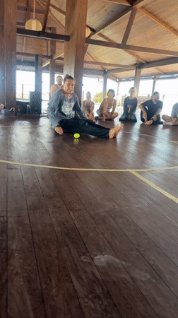 Group gathers in circle for morning activity in Mengwi pavilion