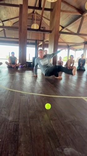Group gathers in circle for morning activity in Mengwi pavilion