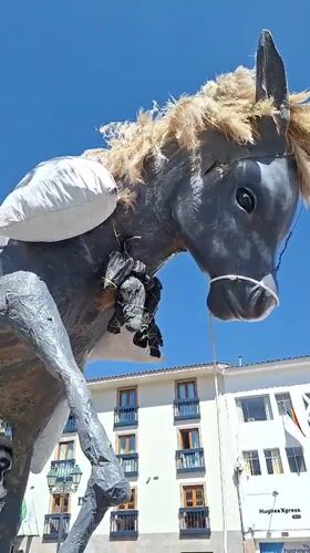 Street parade in Cusco features bands, floats, and folk art effigies