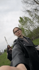 Two women film themselves near railway tracks in Solnechnoye