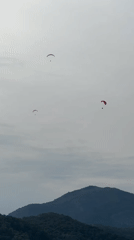 Paragliders spotted over Fethiye Turkey amid cloudy afternoon skies
