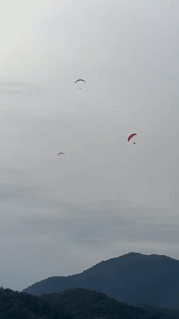 Paragliders spotted over Fethiye Turkey amid cloudy afternoon skies
