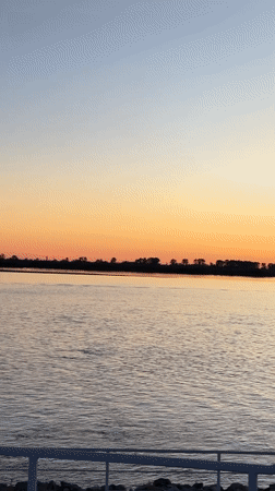 Sunset gathering at Khabarovsk waterfront with boats and city views