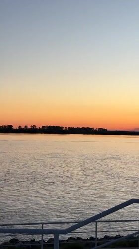 Sunset gathering at Khabarovsk waterfront with boats and city views