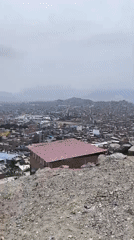 Cyclists pause at scenic overlook above Trujillo, Peru
