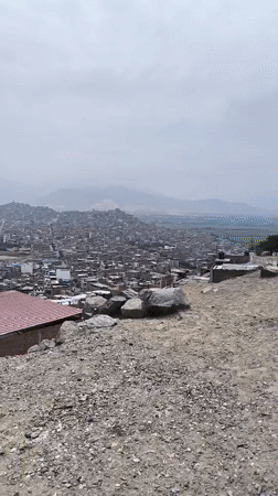Cyclists pause at scenic overlook above Trujillo, Peru