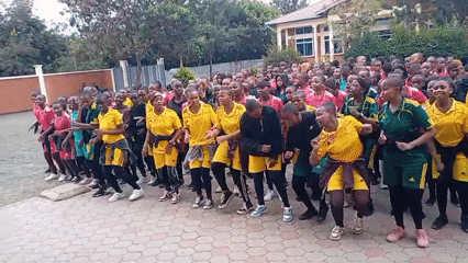 Young dancers gather in colorful sports attire on brick plaza