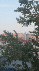 Evening transition captured over Saint Petersburg cityscape with rising moon
