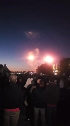 Fireworks light up the Seattle night sky over a watching crowd