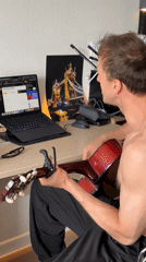 Guitar practice at a cluttered desk in a Russian apartment