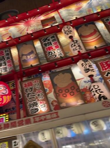 Bustling Osaka street displays vibrant nighttime commercial signage