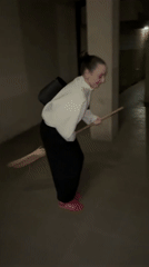 Woman attempts broom riding in Kragujevac hallway