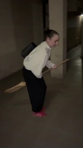 Woman attempts broom riding in Kragujevac hallway