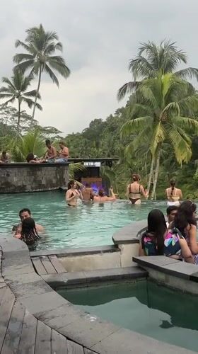 Resort guests enjoy tiered infinity pools in tropical Tegallalang