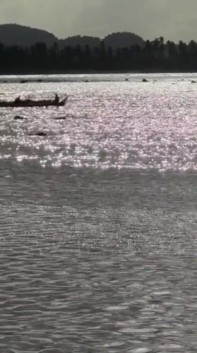 Morning surf and boat activity in General Luna