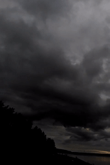 Storm clouds gather over Chaikovsky waterway, concrete structures visible