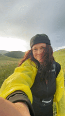 Photo session in yellow raincoat across Russian countryside hills