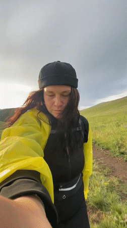 Photo session in yellow raincoat across Russian countryside hills