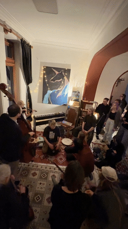 Group gathering on rugs observed in Tbilisi room