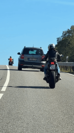 Motorcycles rolling through sunny roads near Morbach, Germany