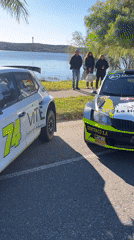 Race cars gather near waterfront in Villa Carlos Paz