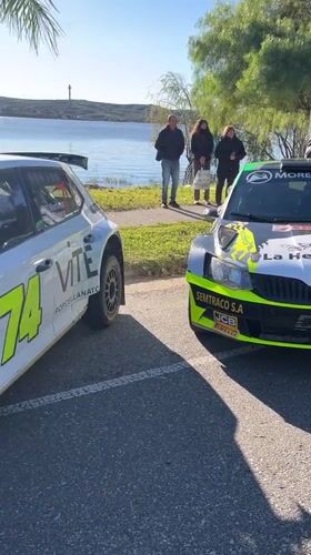 Race cars gather near waterfront in Villa Carlos Paz
