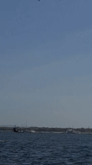 Kitesurfers, jet skis, and beach activity off Denpasar