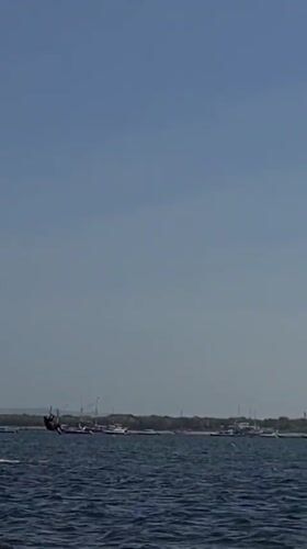 Kitesurfers, jet skis, and beach activity off Denpasar
