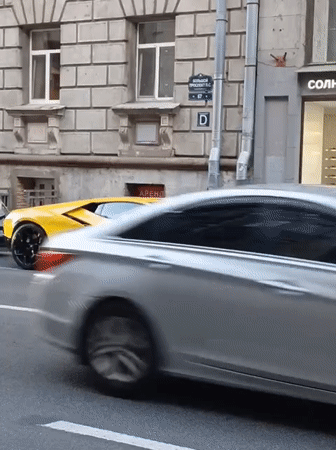 Yellow Lamborghini parked on an ornate Saint Petersburg street at dusk
