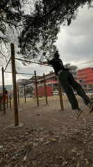 Man performs somersault over pull-up bar in Pokhara park