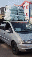 Street scenes captured: overloaded car, pedestrian, advertising bus