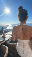Woman dines at sunset terrace overlooking Montenegro coastline