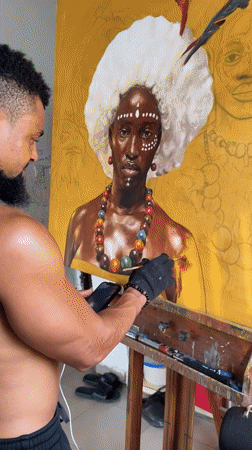 Artist paints portrait in studio workspace in Ado, Nigeria