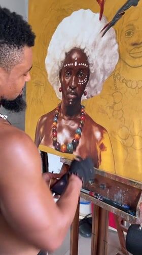 Artist paints portrait in studio workspace in Ado, Nigeria