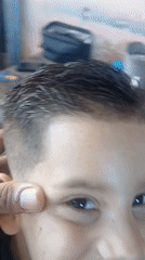 Child gets decorative fade haircut in Porlamar, Venezuela