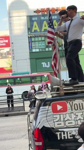 Political demonstration held in Seoul with protesters on platform