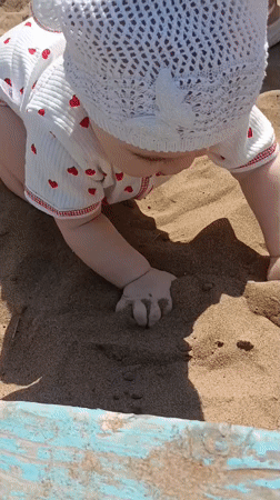 Children play in sandbox during morning in Noviy, Russia
