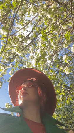 Woman poses among spring blossoms in Yekaterinburg park