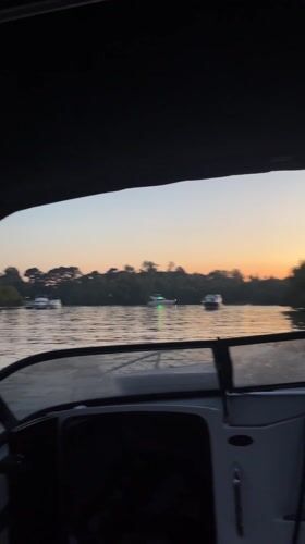 Boats navigate busy waterways near Victoria, Argentina at dusk